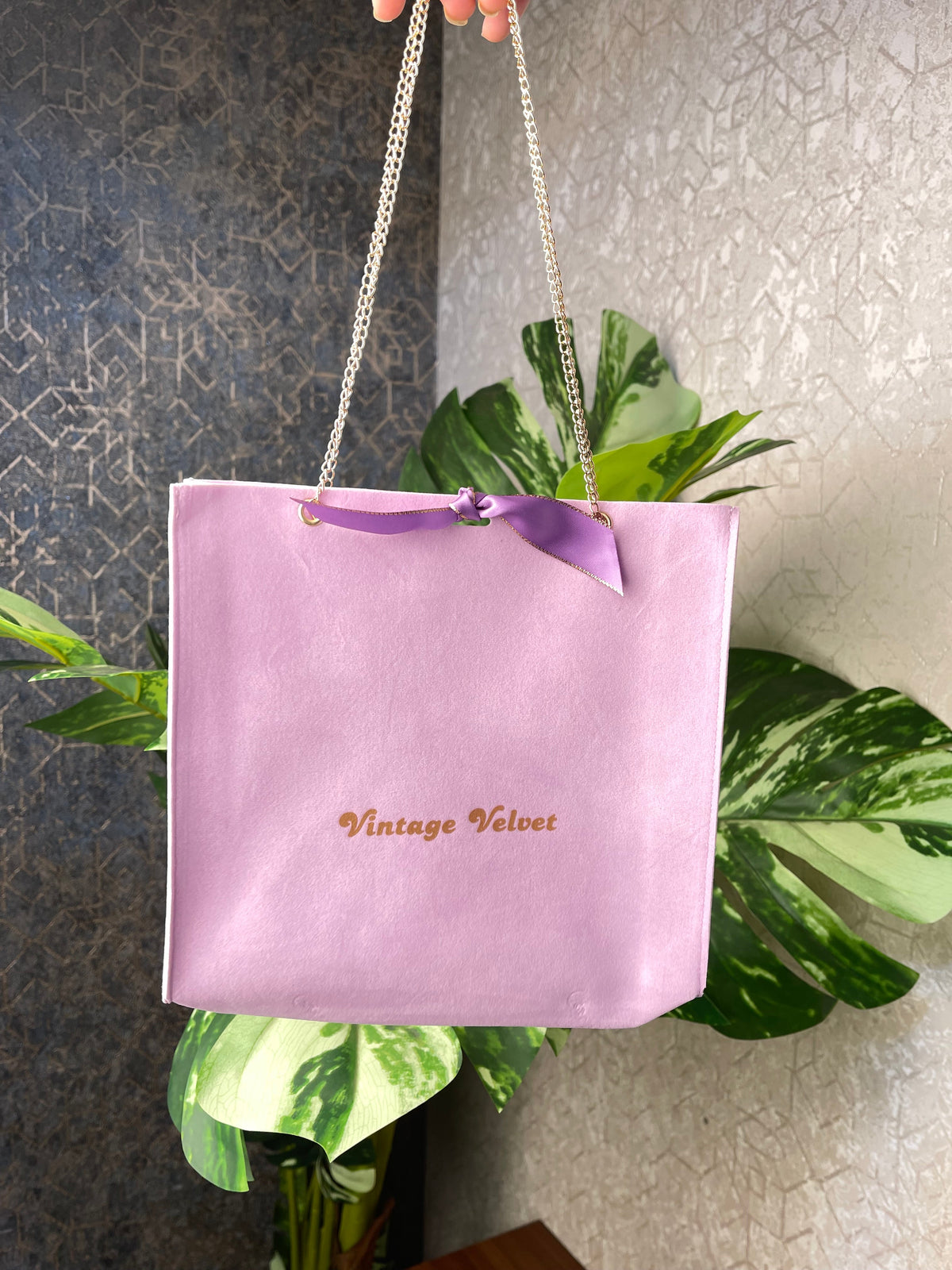 Lilac suede gift bag with supplied golden-edged ribbon